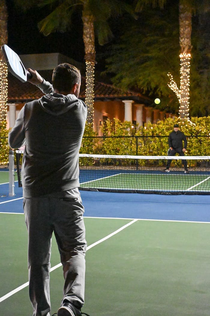 about-04 Engaging pickleball match under lit palm trees at night in Scottsdale.